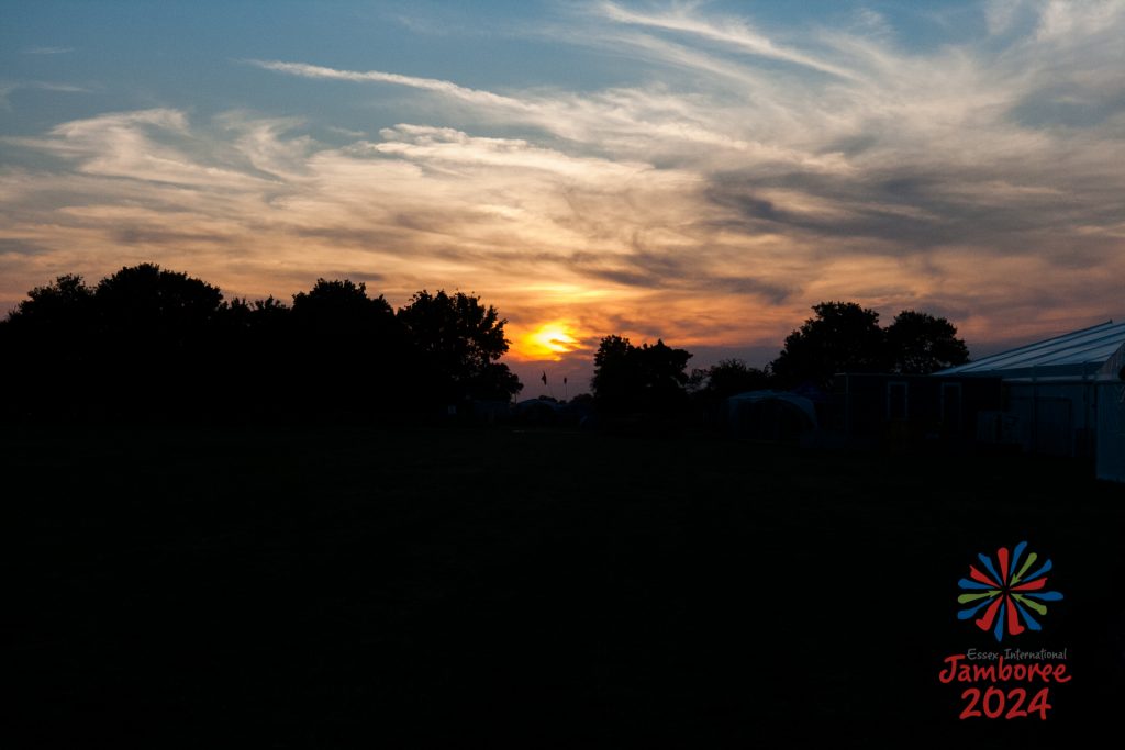 A beautiful orange sunset over the jamboree site, mixing with the clouds. 