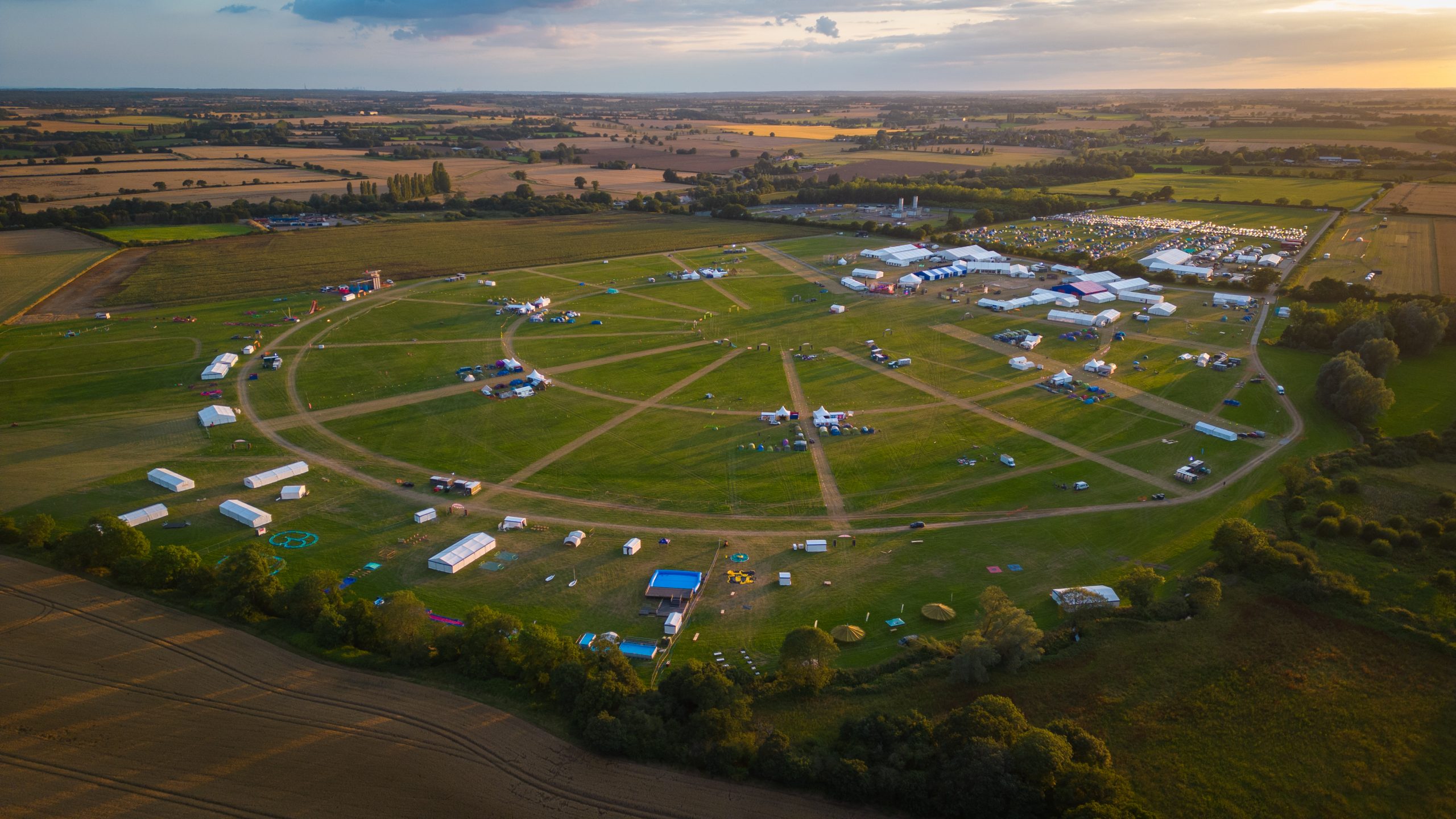 An aerial view of the EIJ campsite featuring large marquee tents, and designated paths