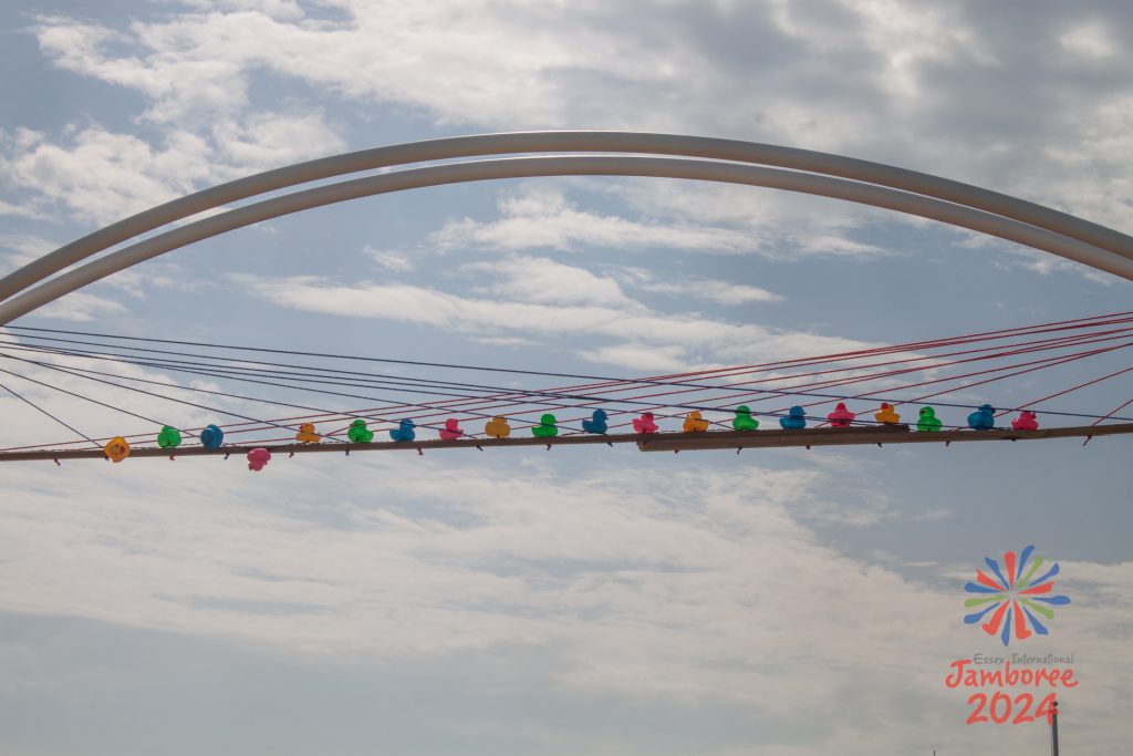 A camp gate decorated with a hoard of plastic ducks