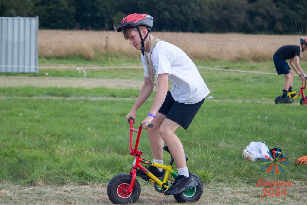 A young person on a very small bike.