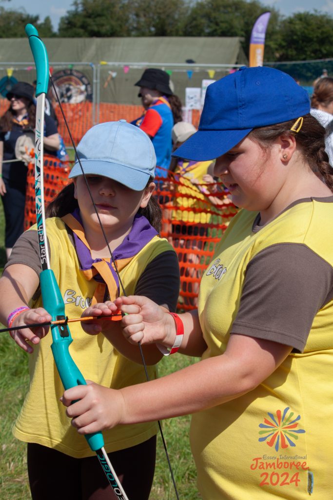 Two Brownies having a go at archery.