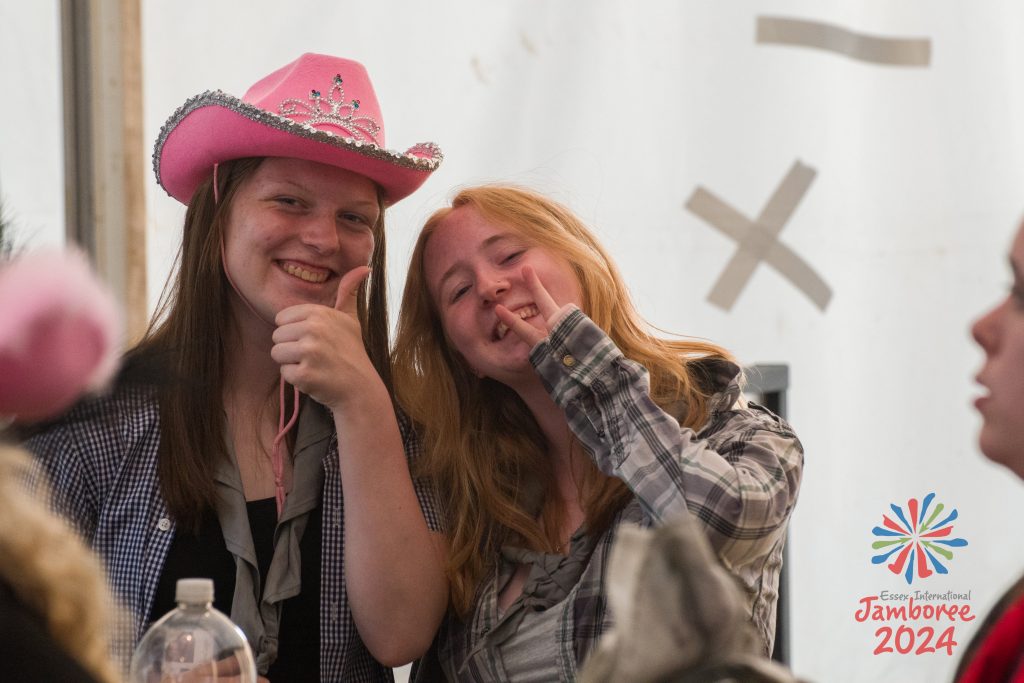 Two girls smiling to the camera in the 14-17 retreat.