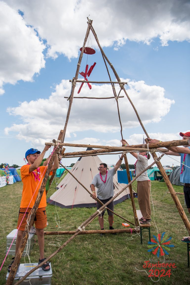A tall tower built out of pioneering poles