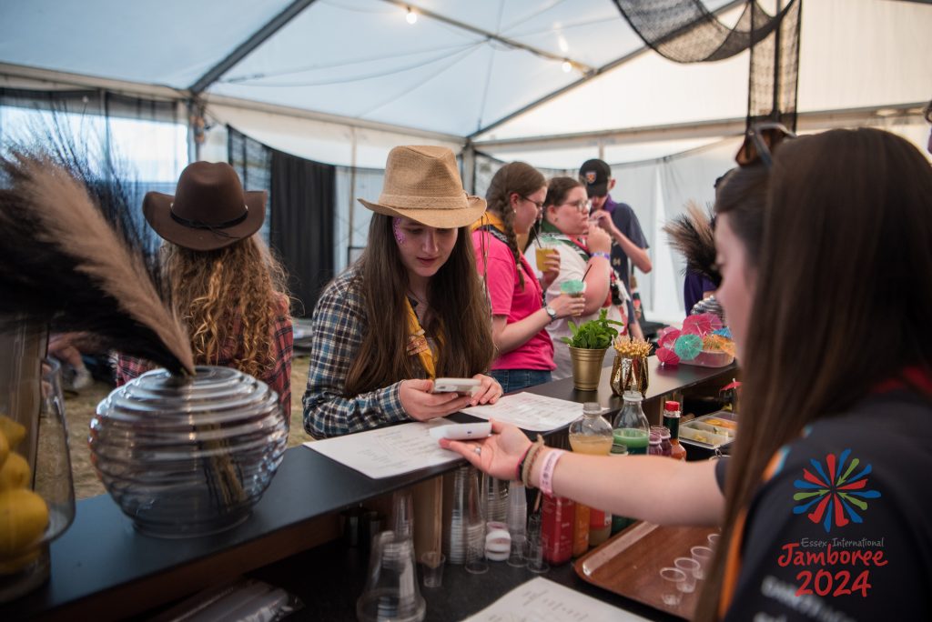 A young person ordering a mocktail at the 14-17 retreat bar. The photo is taken from behind the bar.