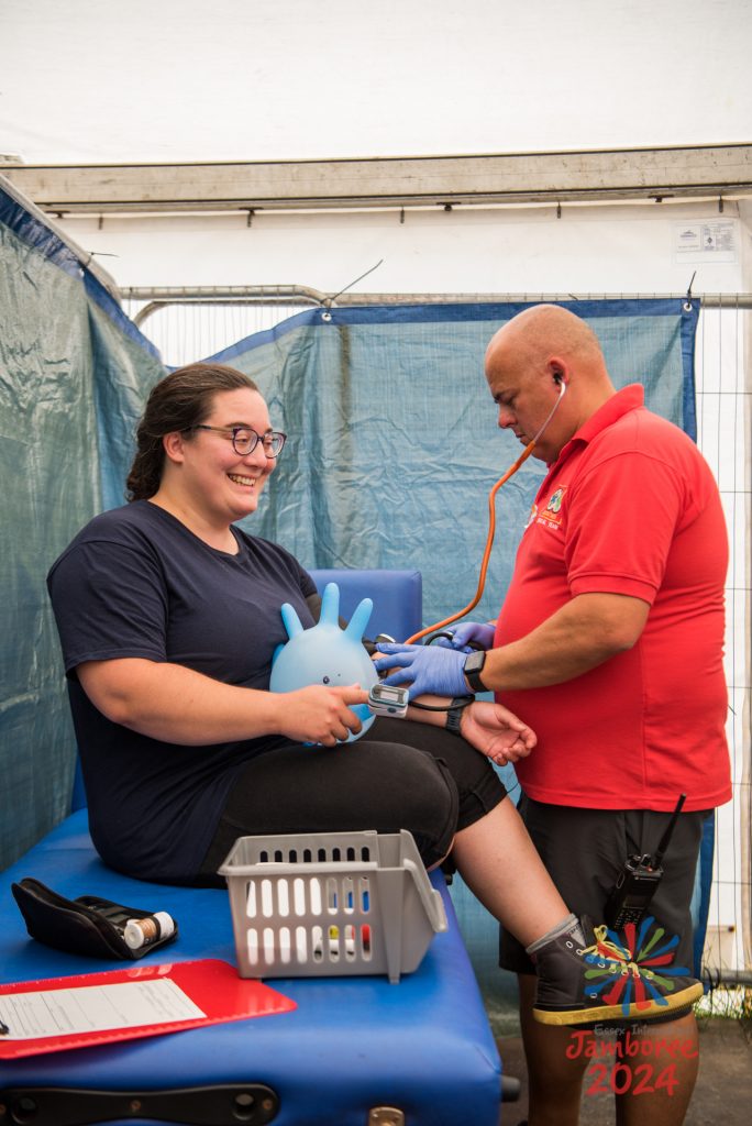 A woman being treated by a member of ScoutMed