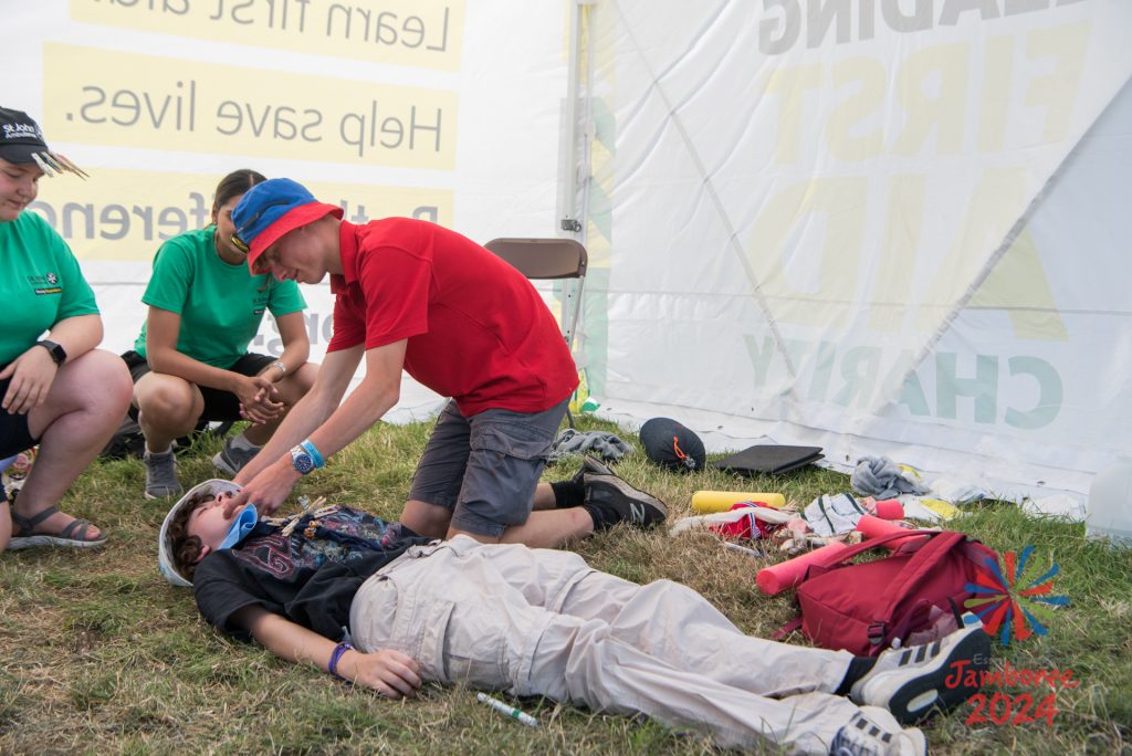 Young people practising the recovery position. 