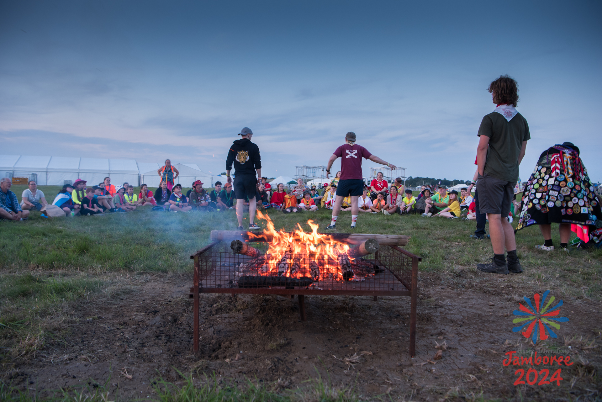 Participants huddled around a campfire.