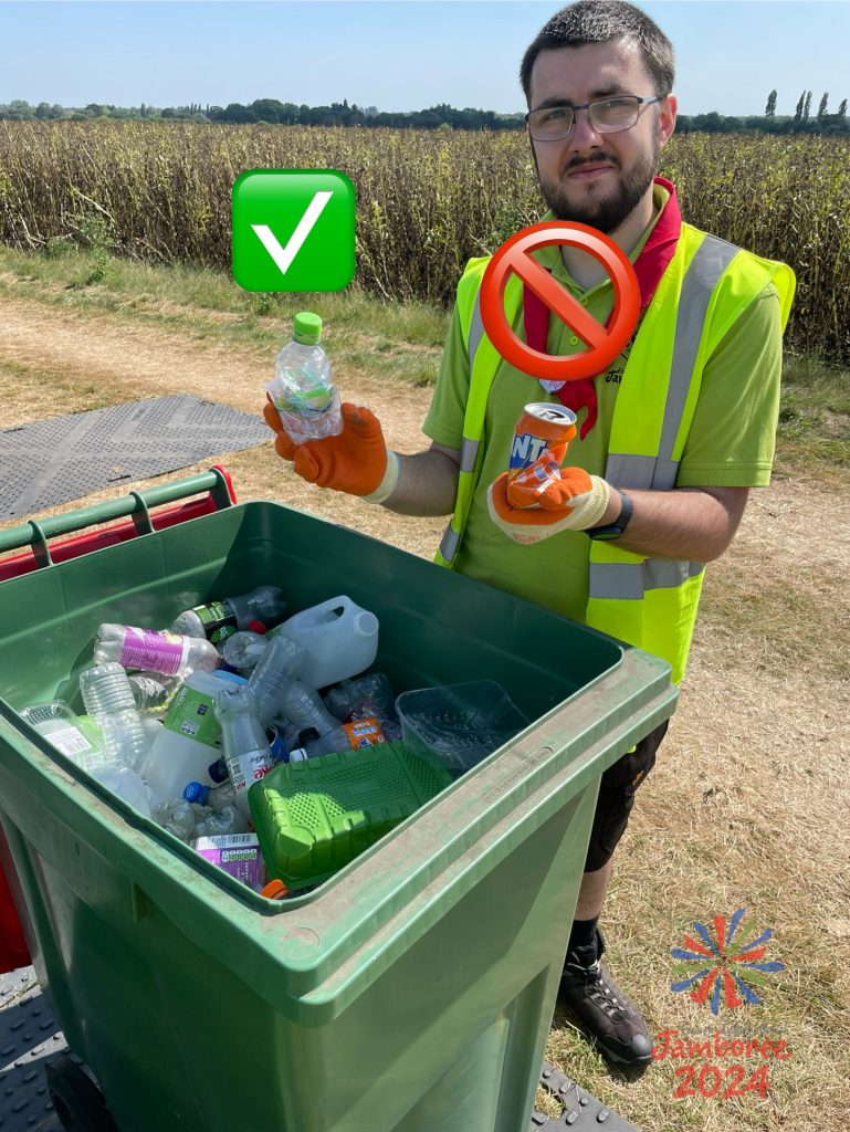 A member of staff demonstrates that a can does not belong in a bin full of bottles