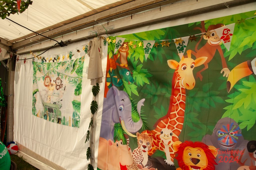 A tent wall decorated with African animal scenes