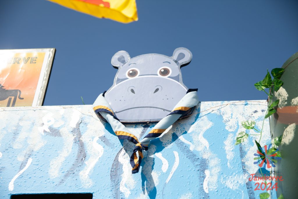 A wooden Hippo wearing a real neckerchief