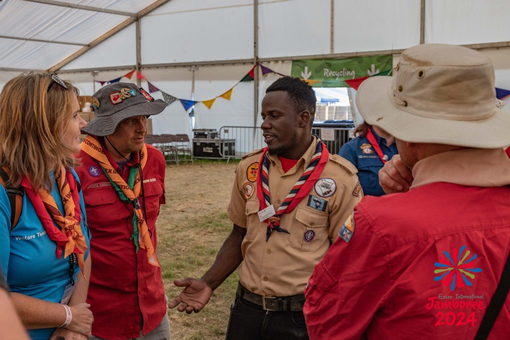 Four Adults in Scouting and Guiding Uniforms standing around having a chat