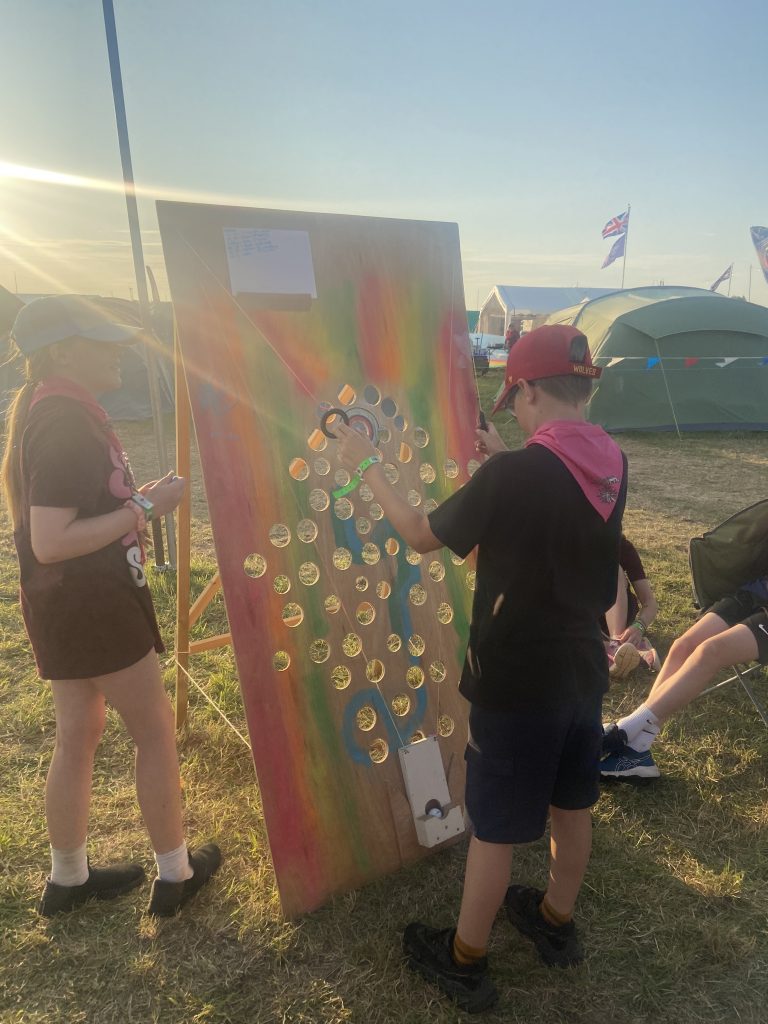 A young person playing a fairground game. 