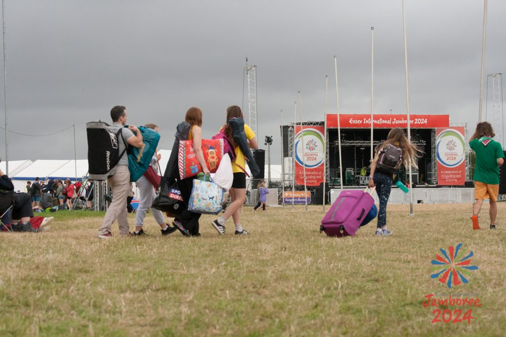 People carrying their belongings past the EIJ main stage, on their way home.