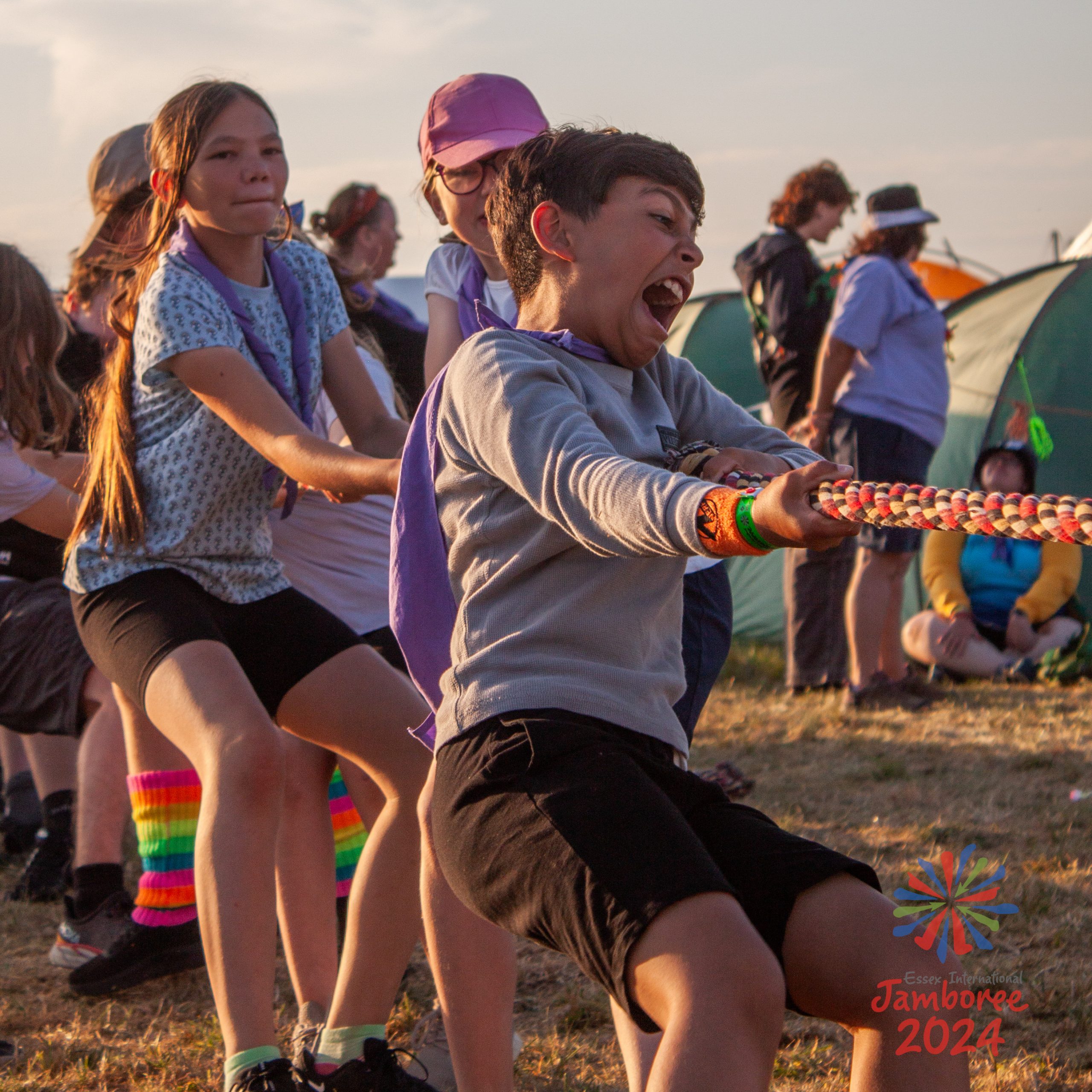 A tug of war - the young person at the front has gotten very into it!