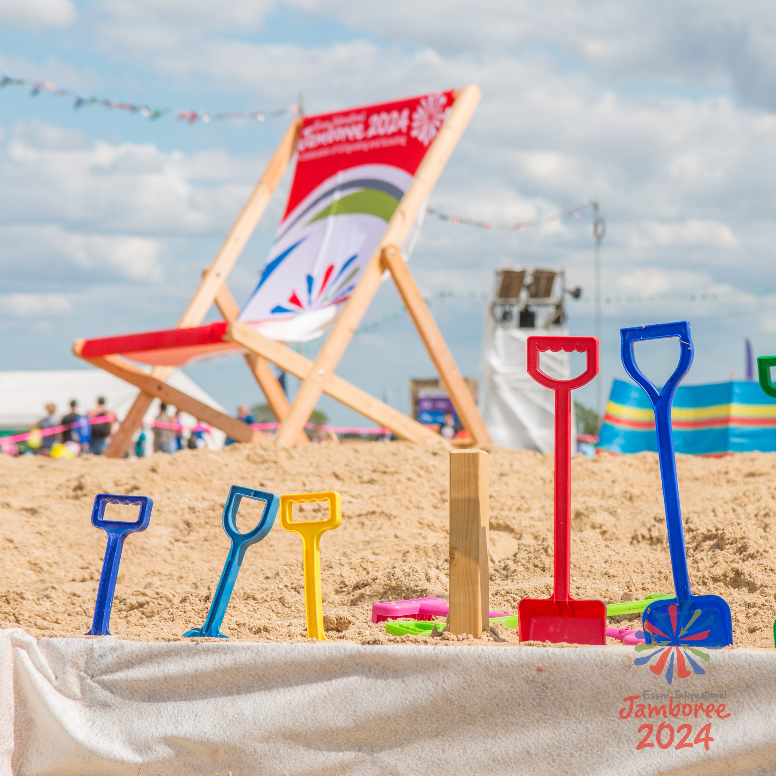 Colourful spades in a line on the beach.