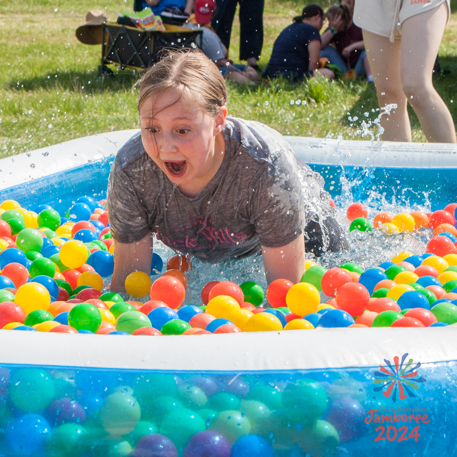 A young person landing in a swimming pool full of colourful balls.