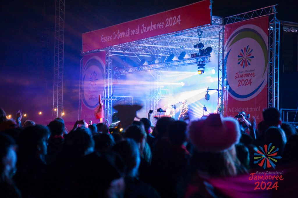 Lots of participants in front of the main EIJ 2024 stage, blue lights shining from the stage.