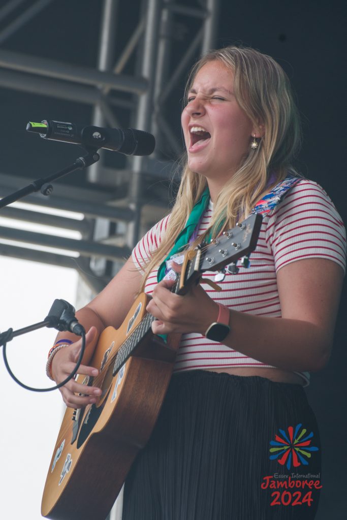 A participant singing while playing guitar.