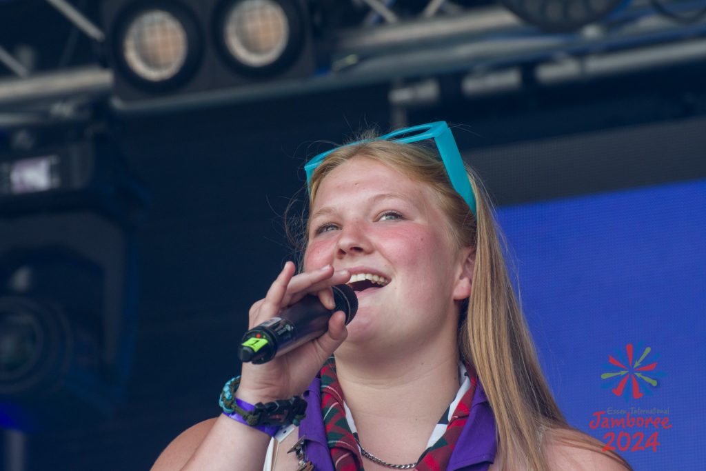 A girl singing into a microphone.