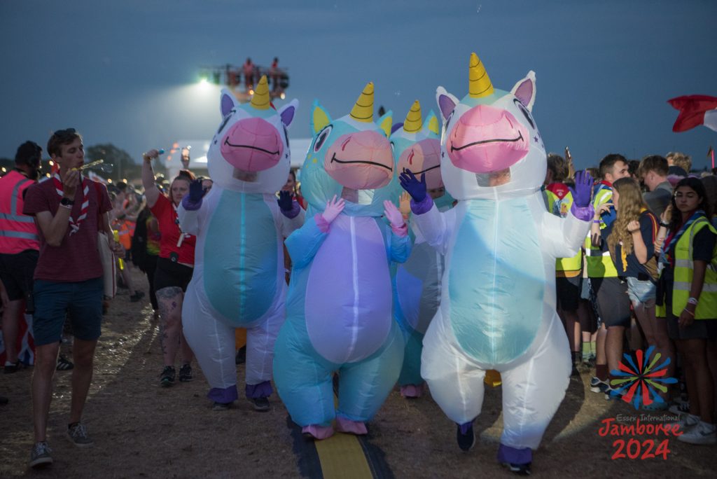 Four people in inflatable unicorn costumes.