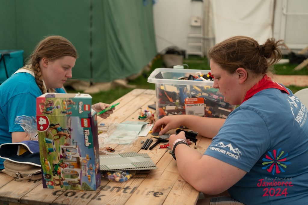 Two members of staff relaxing with some LEGO in staff comforts