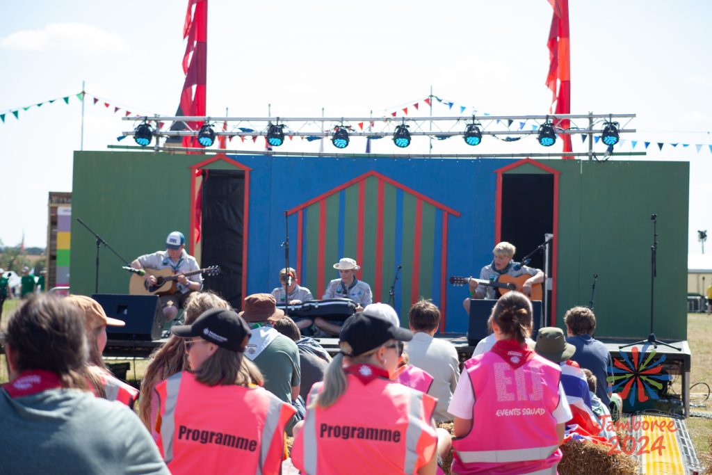 Members of the programme team supervising a performance on the beach stage.