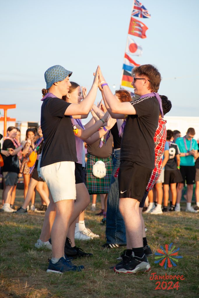 Young people dancing in two lines.