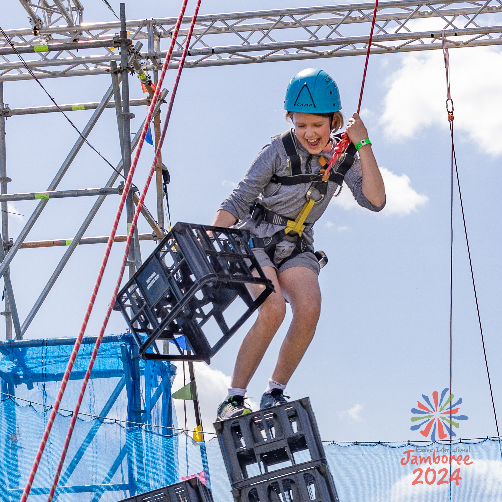 A young person falling during crate stacking.