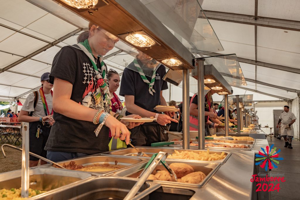 Staff members serving themselves from the dinner buffet