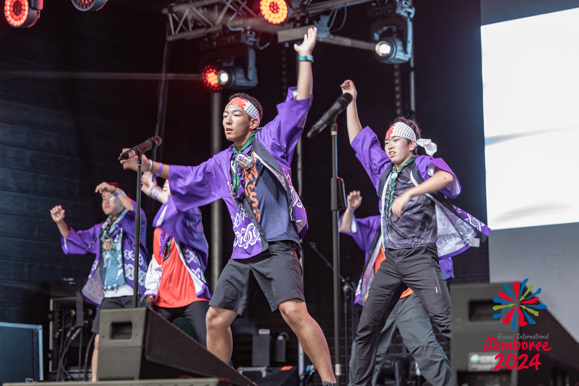 Participants from Japan dancing on stage.