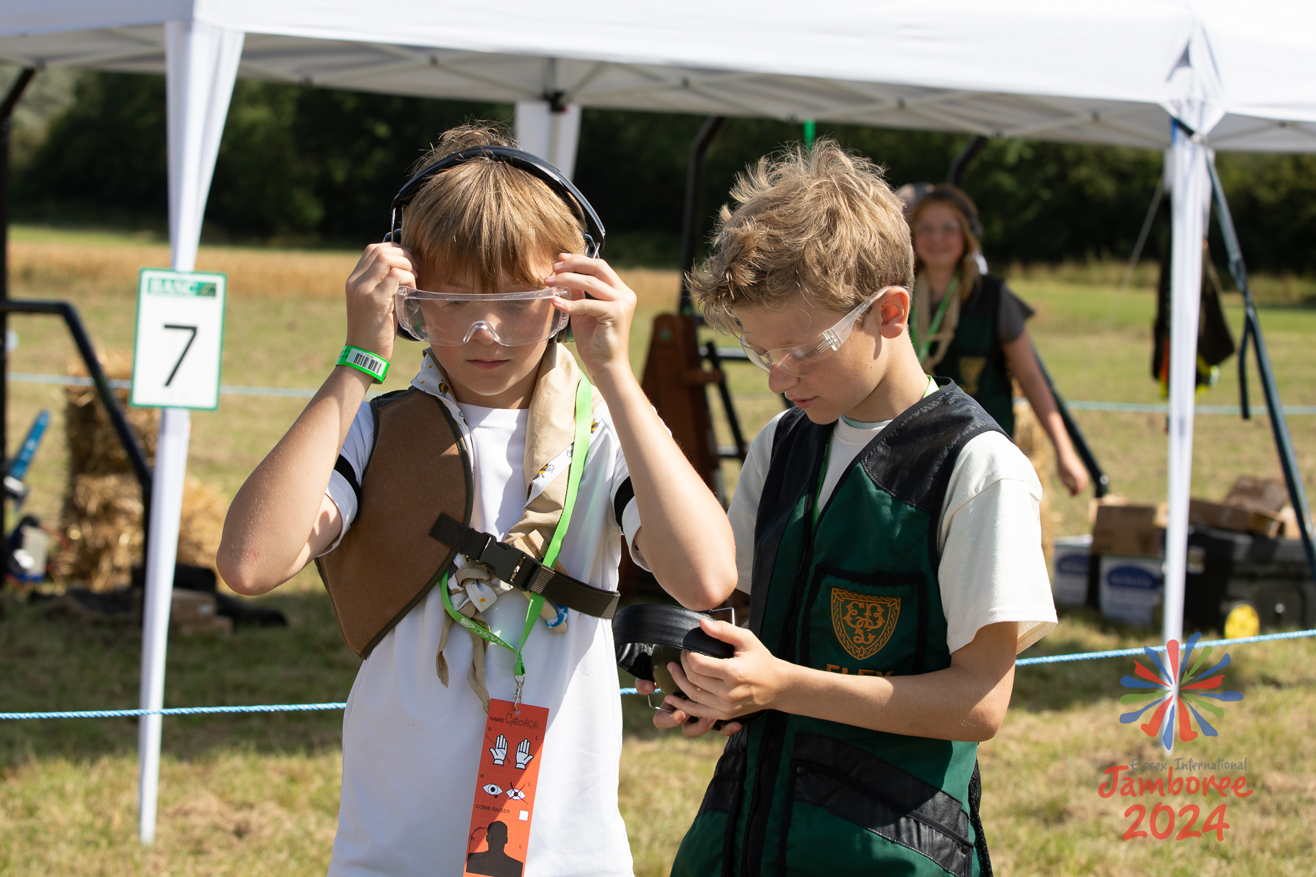 Two participants don protective wear for archery