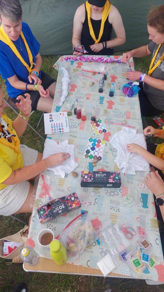 Members of Murray Subcamp sitting at a table taking part in tie-dyeing