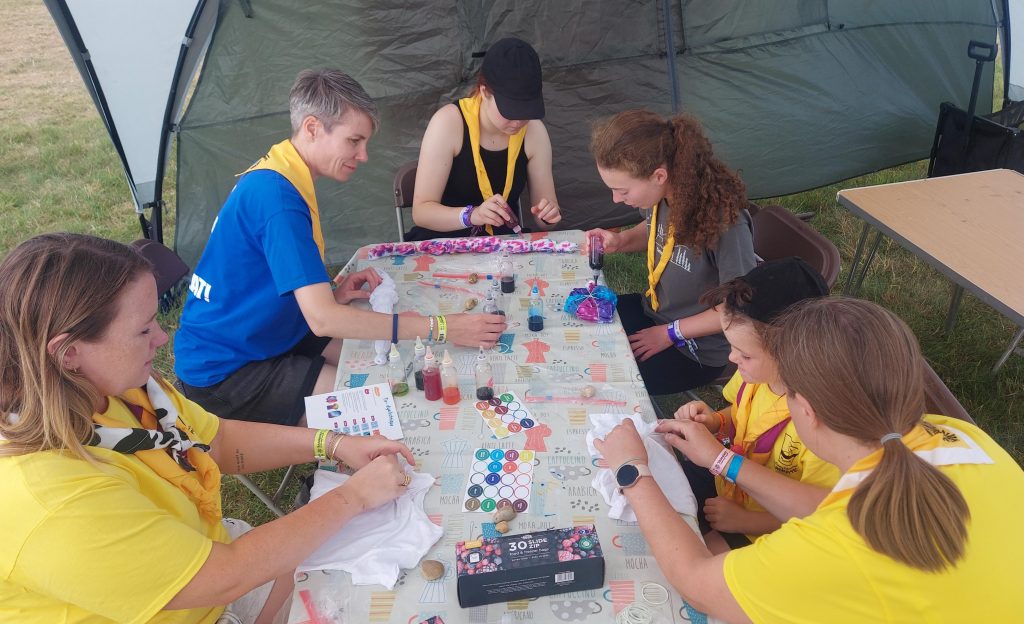 Members of Murray Subcamp sitting at a table taking part in tie-dyeing