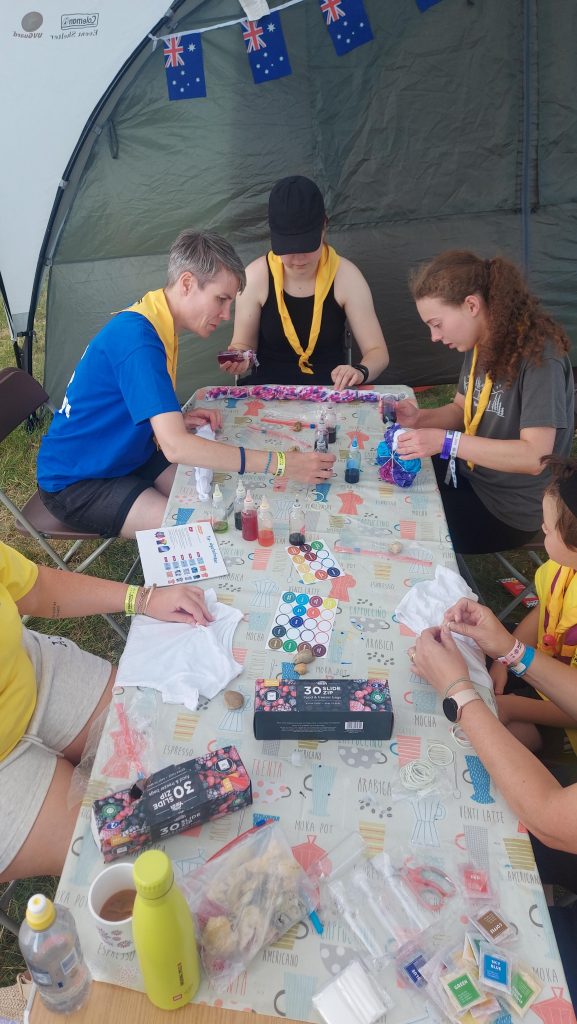 Members of Murray Subcamp sitting at a table taking part in tie-dyeing