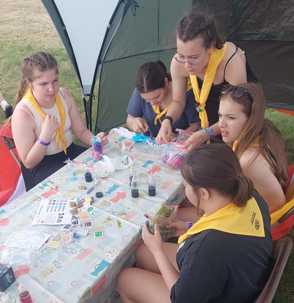 Members of Murray Subcamp sitting at a table taking part in tie-dyeing