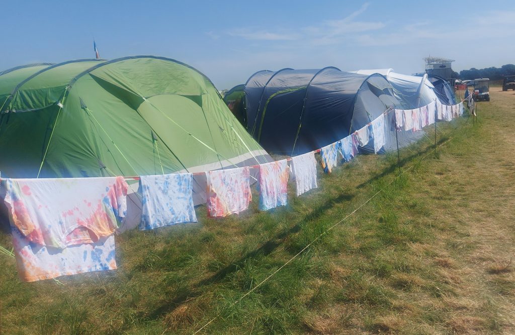 Tie-dyed garments hanging up to dry.