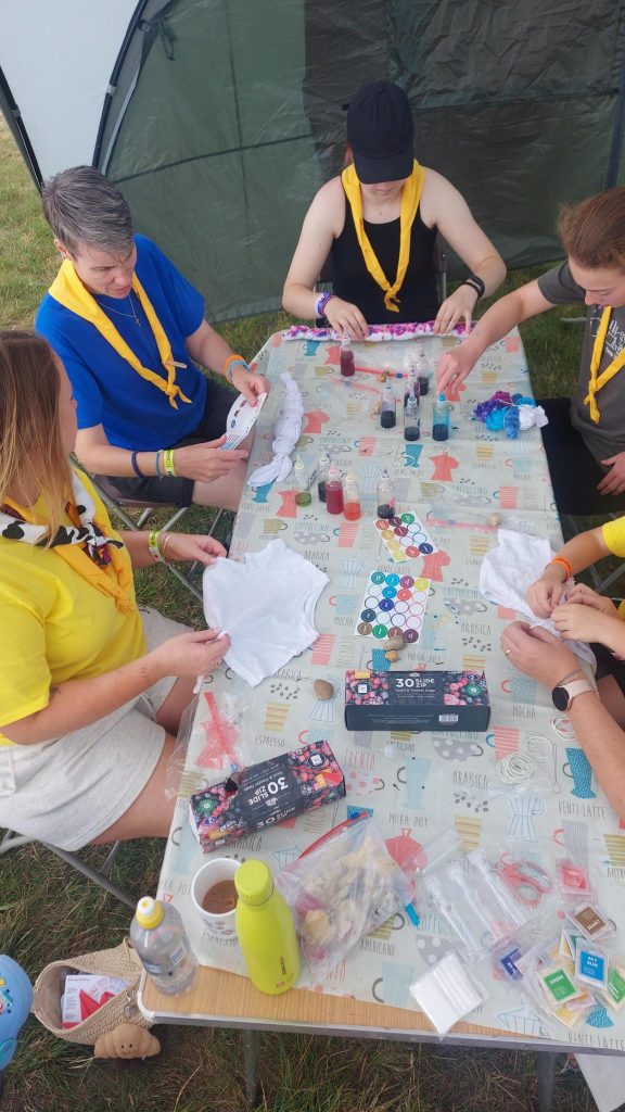 Members of Murray Subcamp sitting at a table taking part in tie-dyeing